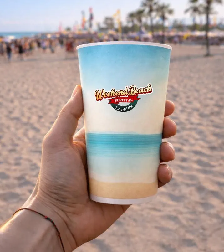 Custom reusable cup on the beach with palm trees in the background