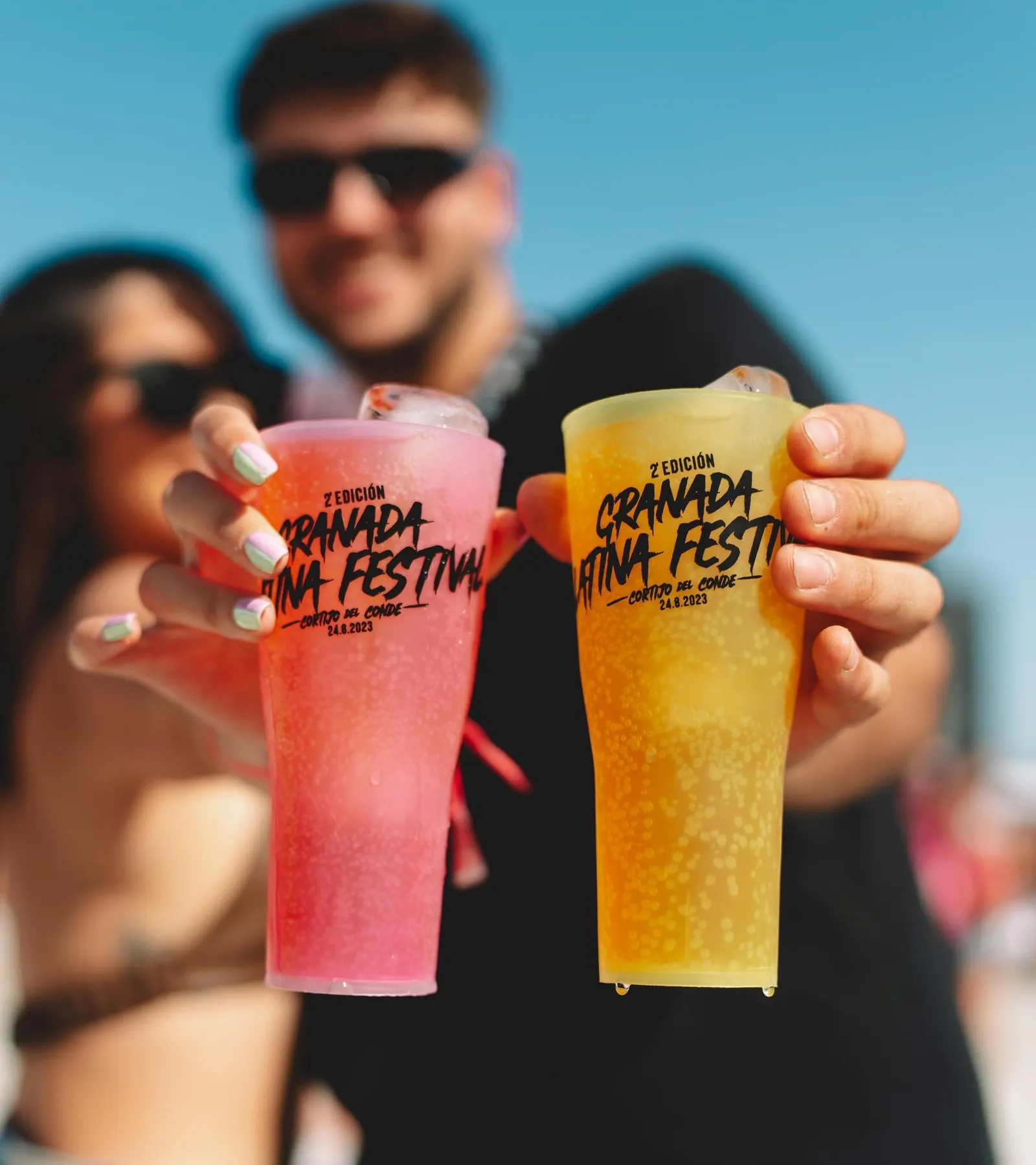 Global Transaction custom reusable cups at a festival at sunset